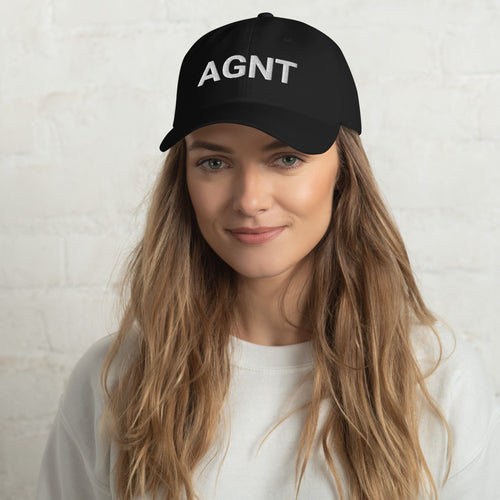 Woman wearing a black cap with a logo on a white background